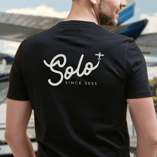 a male model showing the back of a black Solo Since 2025 T-Shirt - First Solo Gift for Pilots - Aviator Apparel