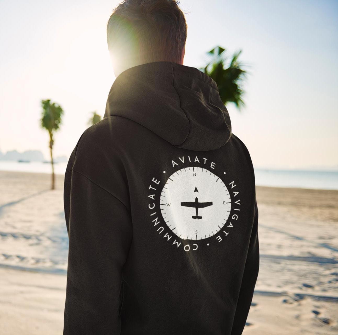 a model showing the back of a black Aviate, Navigate, Communicate Pilot Hoodie - Aviator Apparel