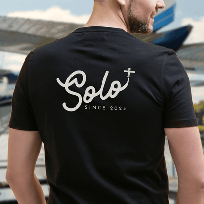 a male model showing the back of a black Solo Since 2025 T-Shirt - First Solo Gift for Pilots - Aviator Apparel