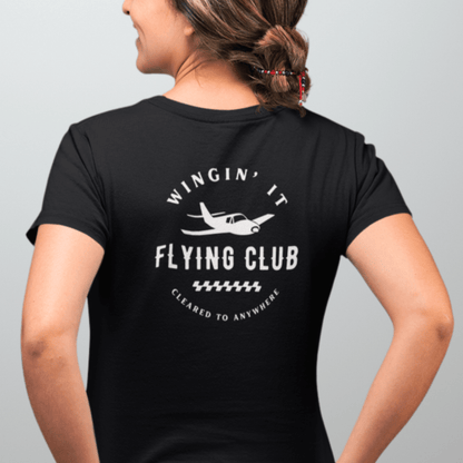 a female model showing the back of a black Wingin' It Flying Club T-Shirt - Aviator Apparel
